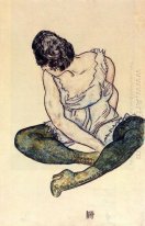 seated woman with green stockings 1918