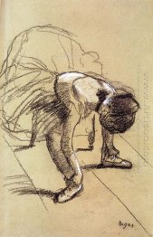 seated dancer adjusting her shoes