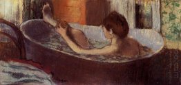 woman in a bath sponging her leg