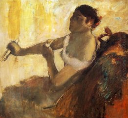 seated woman pulling her glove 1890